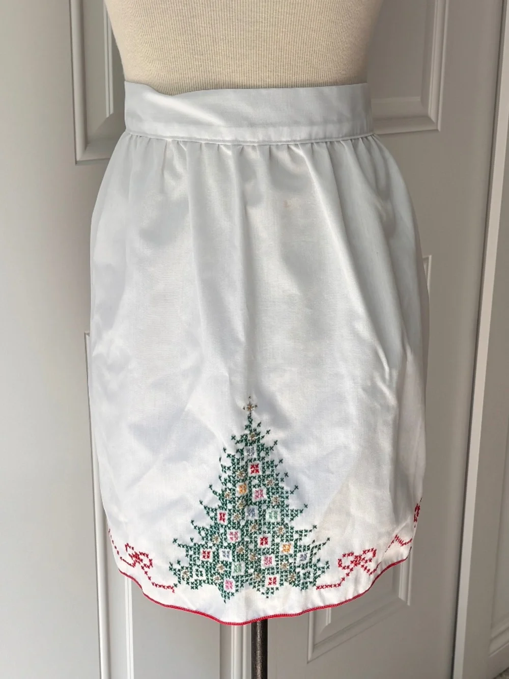 Vintage white half apron featuring hand-stitched cross-stitch Christmas trees